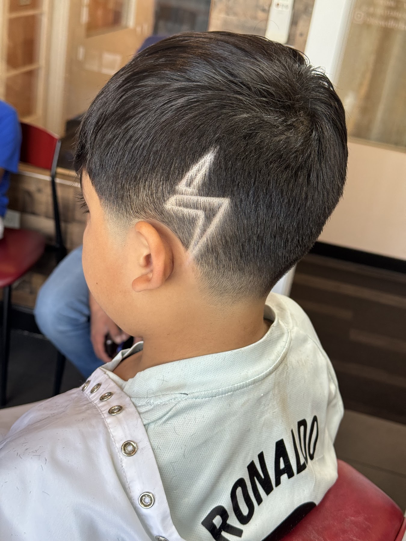 Custom hair design and clean taper by Adrian Carranza in Goodyear, AZ